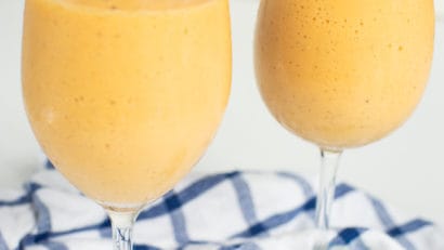easy to make vegan papaya banana smoothie on wine glasses