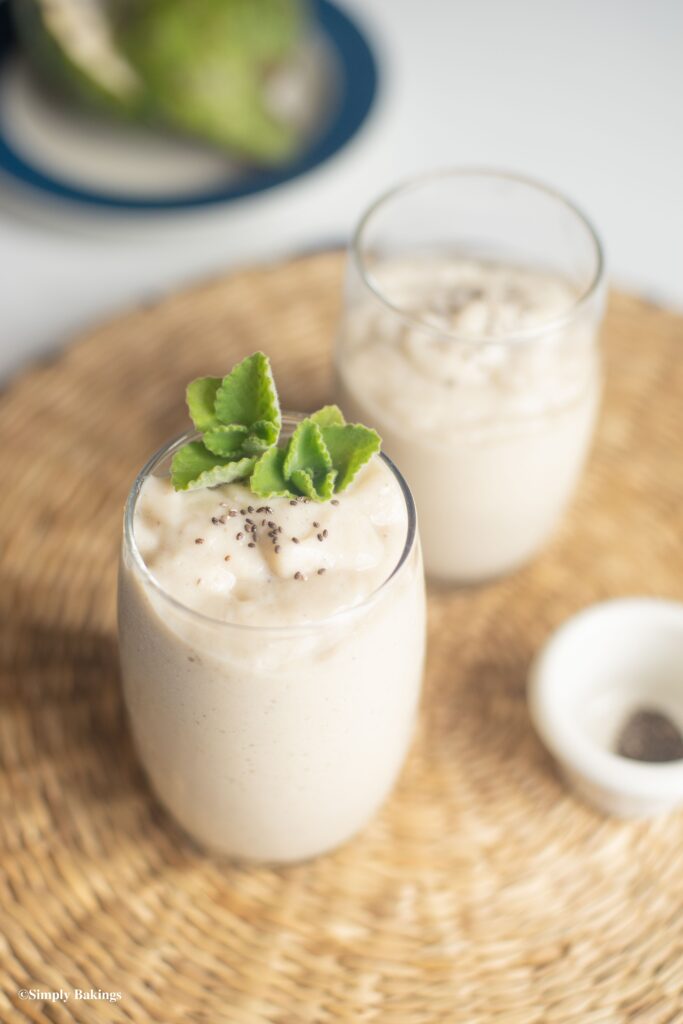 A glass of white smoothie on top of a mat