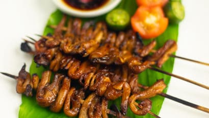 Vegan Isaw on a leaf with soy sauce and tomatoes