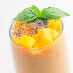 mango banana smoothie topped with mint and chia seeds