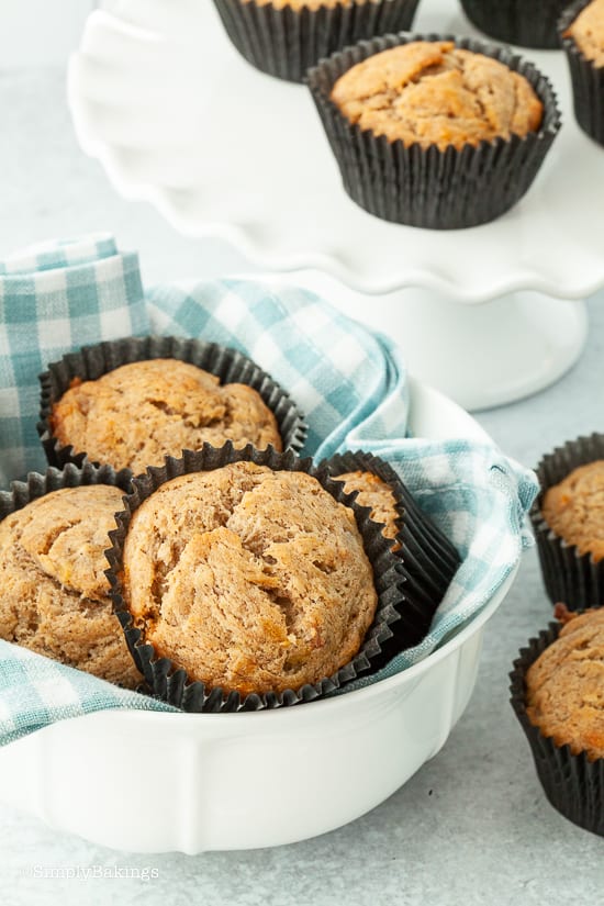 fresh vegan banana muffins on a bowl lined with blue cloth