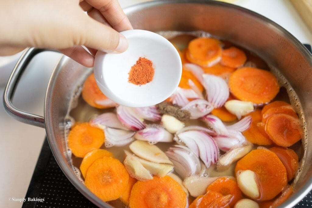adding annatto powder to the mixture