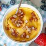 a delicious bowl of homemade cornmeal mush with slices of pitted dates on top