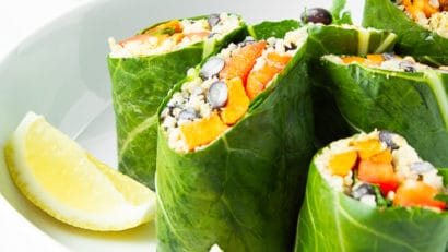 slices fo delicious vegan collard wraps in a bowl with lemon wedges