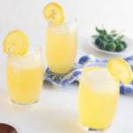 three glasses of calamansi drink served with lemon slices