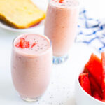 2 watermelon smoothies in a glass on a white table