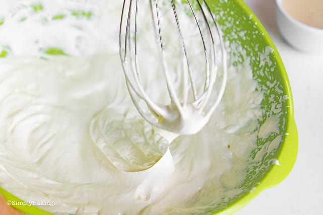 mixing the wet ingredients of the buko pandan ice cream using a wire whisk