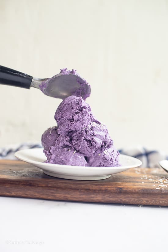 scoops of ube ice cream on a white plate