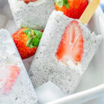 chia seed strawberry popsicles in a white dish