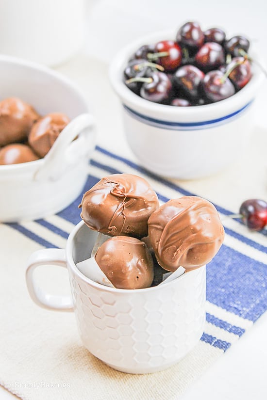 chocolate covered cherries in a white mug