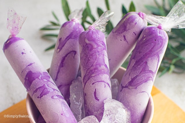ube ice candy in a pink bowl on a cutting board