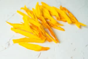 dried mango on a white table