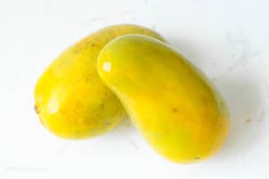 2 filipino mangos on a white table