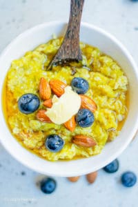 vegan pumpkin oatmeal with blueberries in a white bowl