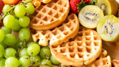 waffles, fruits, on a brown cutting board