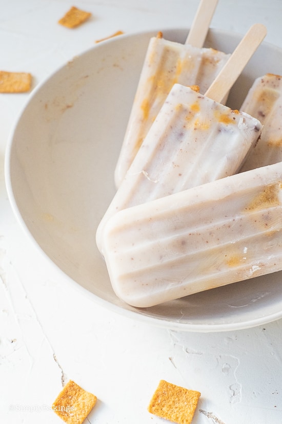 3 cinnamon crunch popsicles in a white bowl