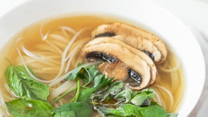 vegan pho with mushrooms and basil in a bowl