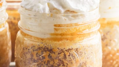 delicious pumpkin pie in mason jars topped with whipped cream