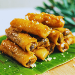 camote spring rolls with a banana leaf on a wooden board