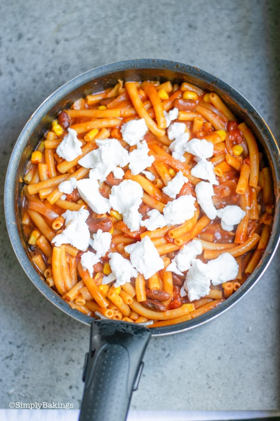 chili bean pasta topped with goat cheese in a pot 