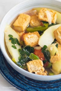 Tofu with vegetables soup in a blue bowl