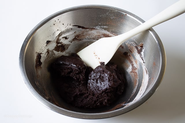 chocolate cookie dough in a bowl with a white spatula