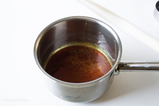 caramel being cooked in a small sauce pan