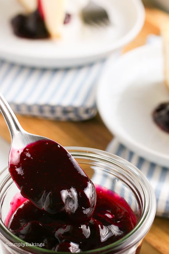 a spoonful of blueberry sauce from a glass container