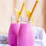 Bright Pink Pitaya Smoothie in two clear glasses