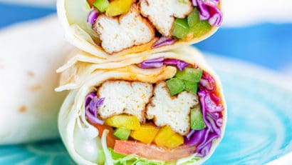 tofu wraps cut in half and placed on a sky blue plate