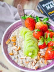 a bowl of spicy oats and chia porridge with a wooden spoon