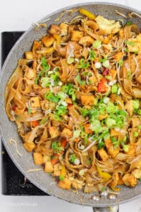 Malaysian Stir Fried Noodles)in a large pan and garnished with green onions