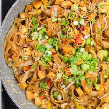 Malaysian Stir Fried Noodles)in a large pan and garnished with green onions