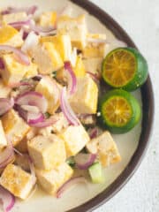 tofu kilawin with 2 sliced calamansi on a plate