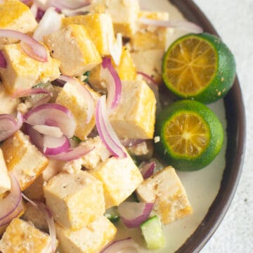 tofu kilawin with 2 sliced calamansi on a plate