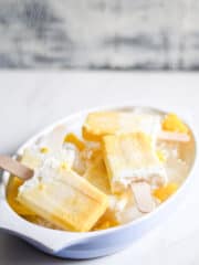 Piña Colada Popsicles crowded in a white bowl