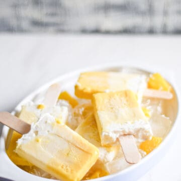 Piña Colada Popsicles crowded in a white bowl