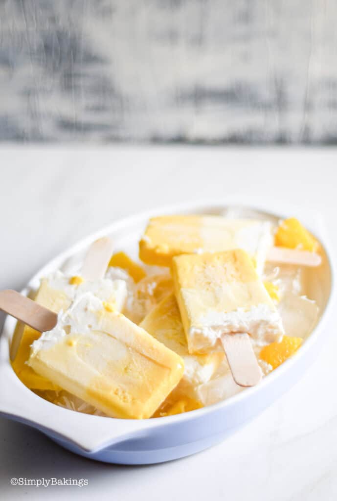 Piña Colada Popsicles crowded in a white bowl