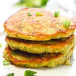 a stack of Zucchini Pancakes garnished with green onions