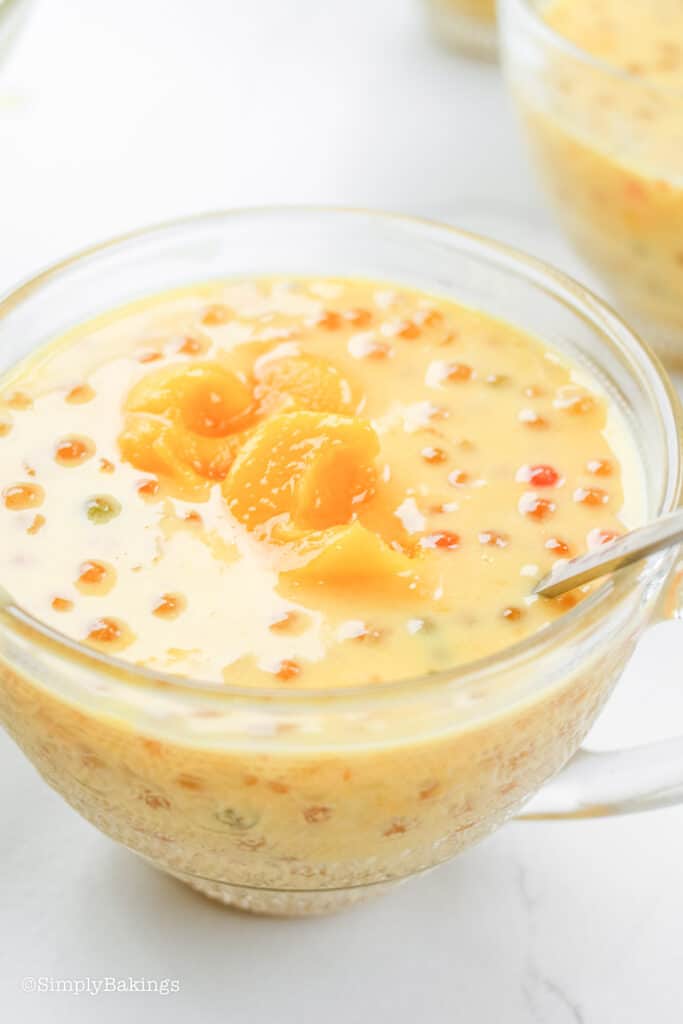 delicious mango tapioca in a glass cup with stainless spoon