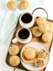 zuchinni muffins and cups of chocolate drinks in a tray