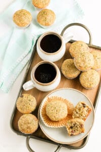 zuchinni muffins and cups of chocolate drinks in a tray