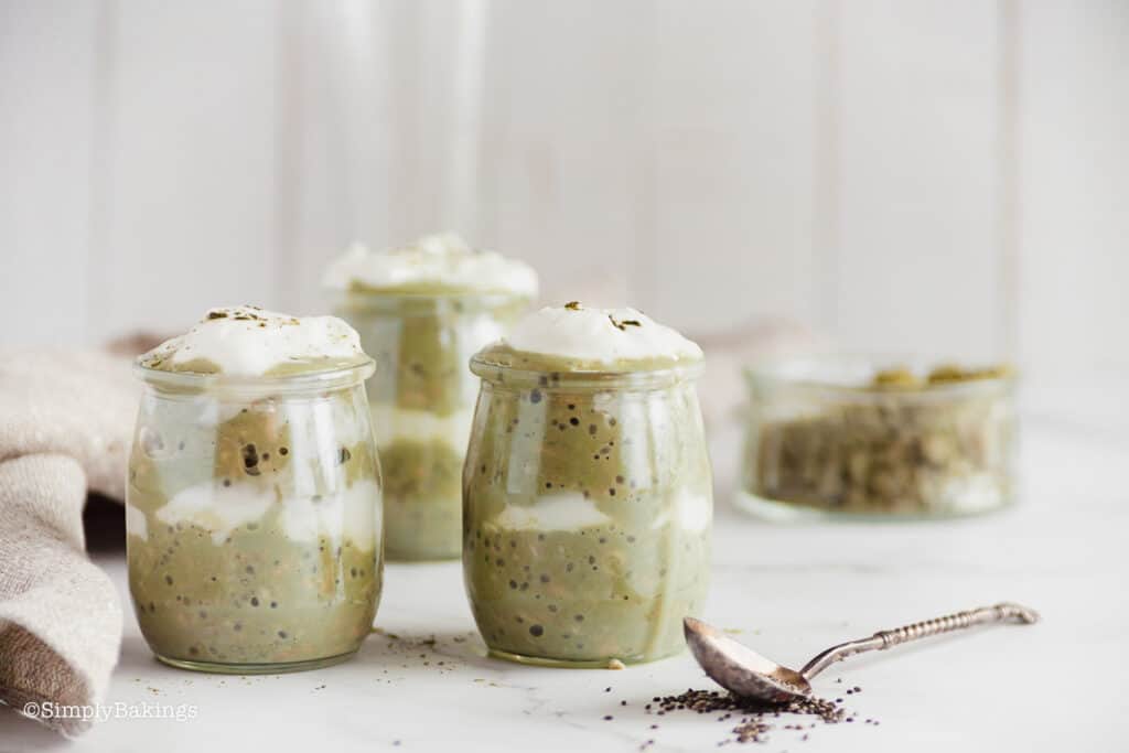 cups of matcha overnight oatmeal with a spoon on the table