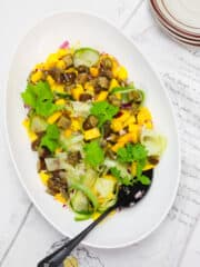 savory mango salad in a white large bowl
