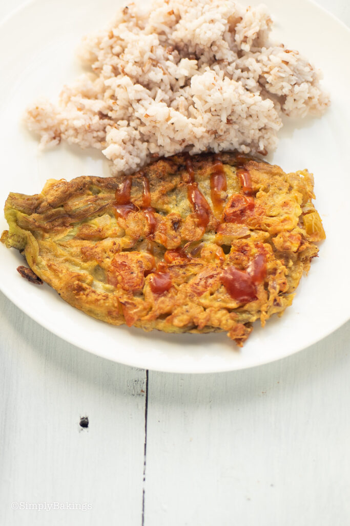 Hot rice and tortang talong on a plate