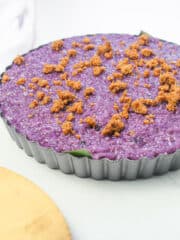 ube biko topped with latik in a tart pan