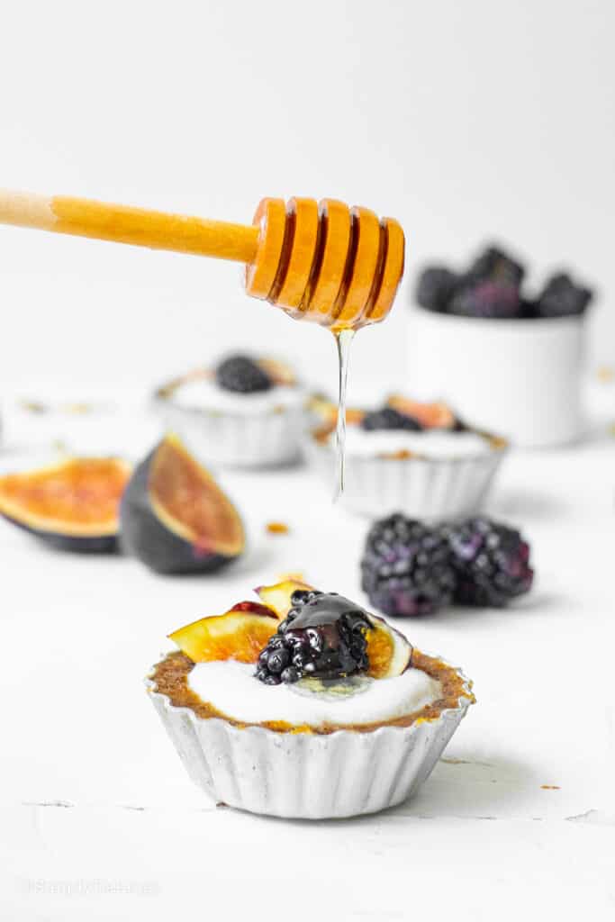 mini fig blackberry tart topped with honey