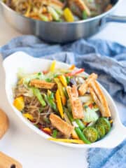 healthy and delicious vegan pancit sotanghon in a white bowl topped with fried tofu