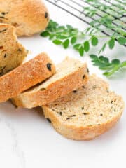 slices of malunggay whole wheat bread loaf with fresh moringa leaves on the side