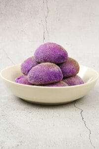 ube cheese pandesal in a white bowl